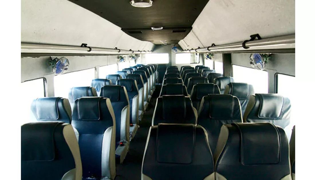 High-back seating and centre aisle inside an MJH bus
